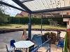Photo of covered play area on paved area beside the school.